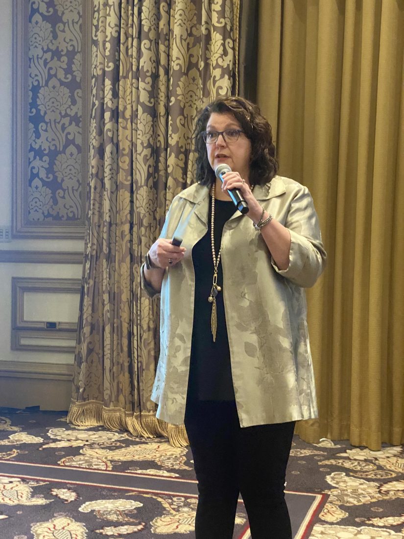 Penny Reed speaking on stage